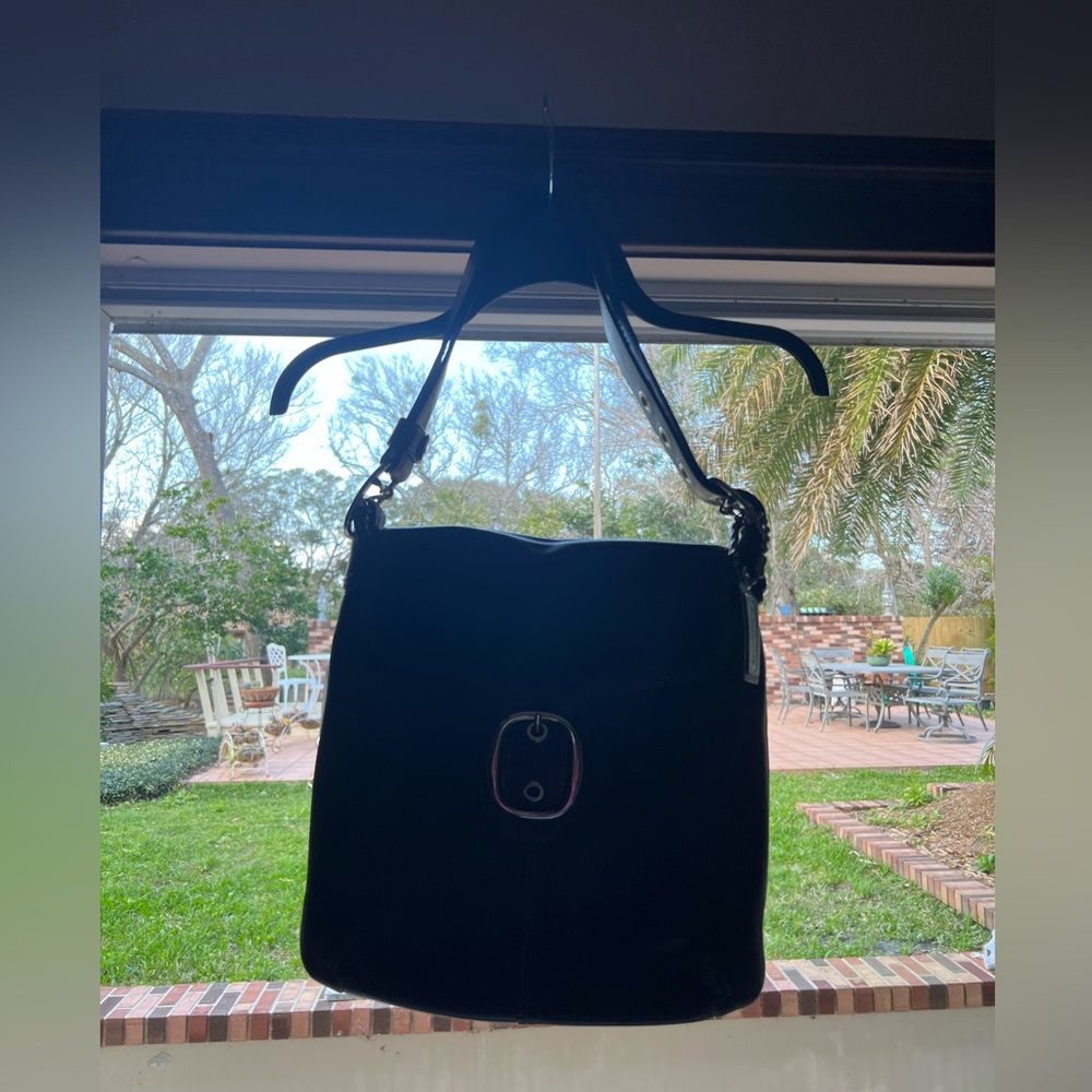 Black Coach shoulder bag w/ buckle closure.